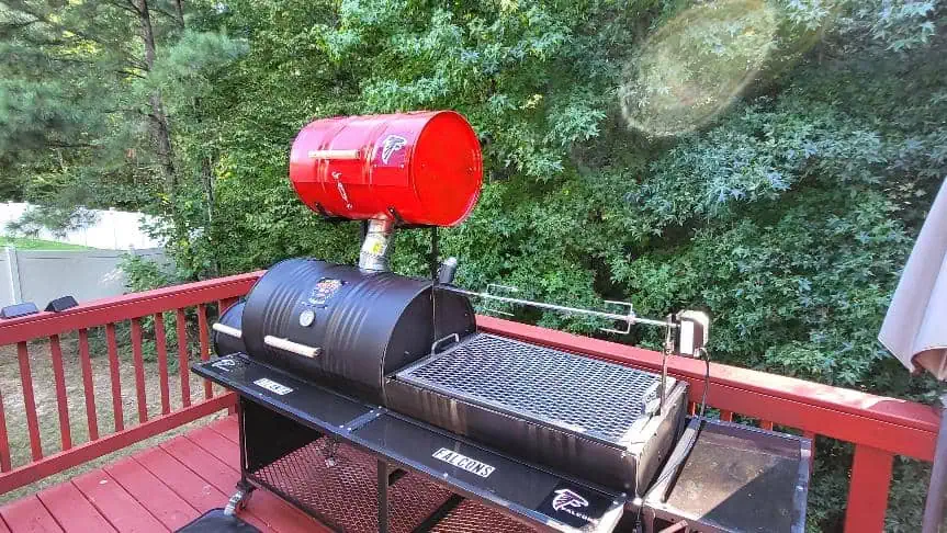 Moss Grills outdoor barbecue with red propane tank and grilling surface.
