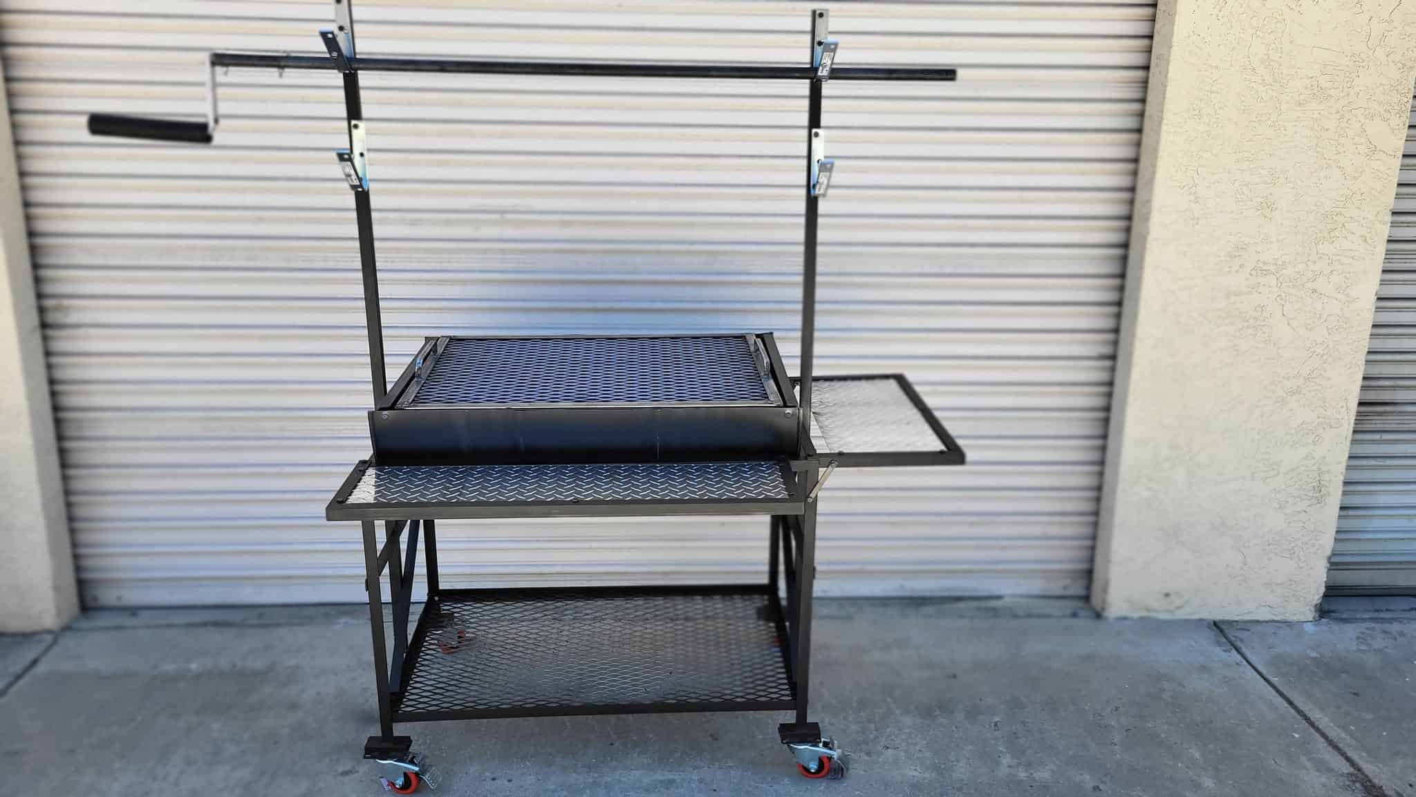 Portable outdoor BBQ grill cart with side shelf and wheels.